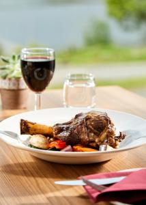 a plate of food and a glass of wine at Clan Macduff Hotel in Fort William