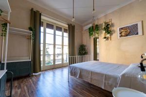sypialnia z łóżkiem i dużym oknem w obiekcie Locanda Popolare w mieście Aci Castello