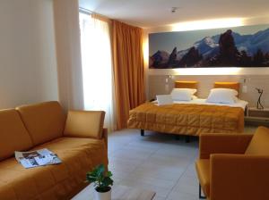 Ліжко або ліжка в номері Hotel Tamaro