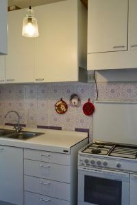 a kitchen with a sink and a stove top oven at Two bedrooms Capri style home near Piazzetta in Capri