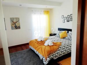 a bedroom with a bed with two towels on it at Sunny Retreat in Luz +21 photos