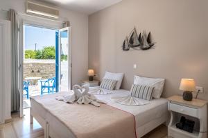 a bedroom with a bed with a towel on it at Ayeri Hotel in Parikia