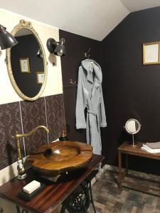 a bathroom with a wooden sink and a mirror at Stairs to Heaven in Ventspils +35 photos