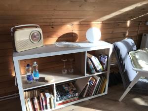 a tv sitting on top of a book shelf at Stairs to Heaven in Ventspils