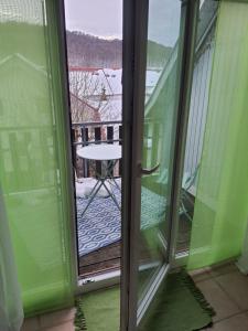 an open glass door with a view of a balcony at Ferienwohnung Brendle in Sankt Johann
