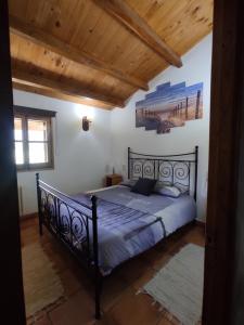 a bedroom with a black bed in a room at FINCA MAS GUIXOT relax y natura in Montagut +28 photos