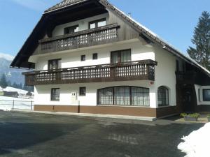 a building with a balcony on top of it at Apartments Bor in Bohinj