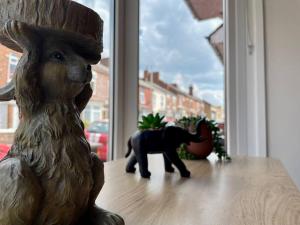 a statue of a bear and an elephant in a window at Western House - By Sigma Stays in Crewe