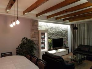 a living room with a couch and a television at Apartment Dasic in Bar