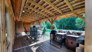 a screened in porch with a grill and a stove at Kura pod Złotym Kogutem in Kudowa-Zdrój