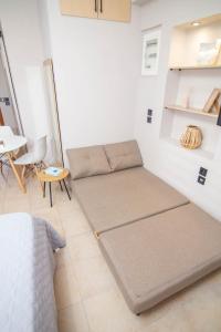 a room with a bed and a table and chairs at Le Magne Apartments Kardamili in Kardamili