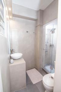 a bathroom with a sink and a toilet and a shower at Le Magne Apartments Kardamili in Kardamili