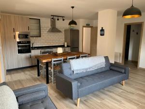 a kitchen and living room with a couch and a table at Marquina Rural in Cubillo del Butrón