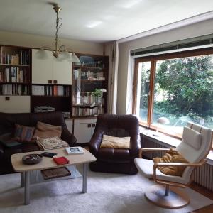 sala de estar con sofá, sillas y ventana en kunst-at-home en Bad Zwischenahn