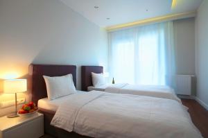 Posteľ alebo postele v izbe v ubytovaní Oxygen Residence