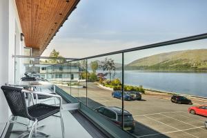 a balcony with a chair and a view of the water at Clan Macduff Hotel in Fort William
