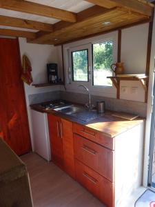 a kitchen with a sink and a counter top at La pause tiny in Ploërmel