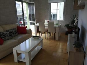 a living room with a couch and a table at Sobre la villa 12 in Neda