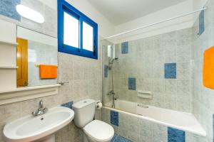 a bathroom with a toilet and a sink and a tub at Villa Galazio by Villa Plus in Argaka +27 photos