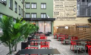 a restaurant with tables and chairs in front of a building at Thon Hotel Astoria in Oslo