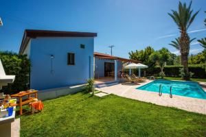 a villa with a swimming pool and a house at Villa Ibiscus by Villa Plus in Polis Chrysochous