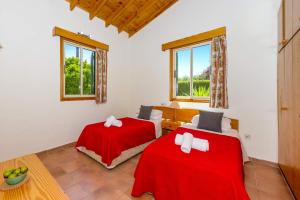 a room with two beds and a table and windows at Villa Ibiscus by Villa Plus in Polis Chrysochous +16 photos