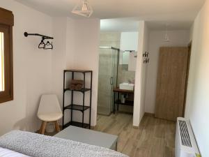 a bedroom with a bed and a bathroom with a shower at Marquina Rural in Cubillo del Butrón +38 photos