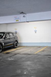 a silver car parked in a parking garage at Apartamenty na Wyspie - Villa Pegaz - Parking in Świnoujście
