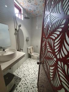 baño con aseo, lavabo y puerta en Kim Ngoc Khanh Hotel en Tuy Hoa