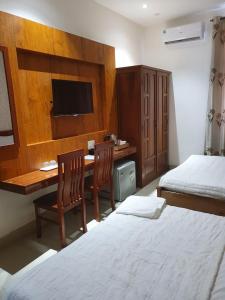 Postel nebo postele na pokoji v ubytování Kim Ngoc Khanh Hotel