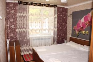 a bedroom with a bed and a window at Guest House Jamal in Naryn