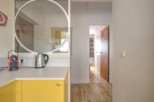 a bathroom with a mirror and a yellow cabinet at La Perrinière appartement face mer in Royan +9 photos