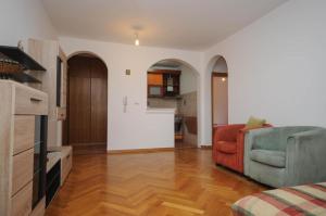 a living room with a couch and a kitchen at Apartment Jana in Petrovac na Moru