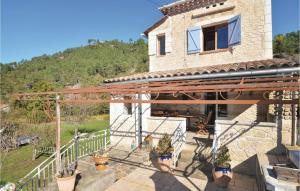 a building with a patio with potted plants on it at Awesome Home In Bessges With Wifi in Bessèges