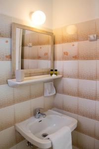 a bathroom with a sink and a mirror at Maria's Apartments in Kavos +28 photos
