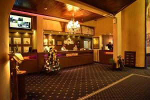 a restaurant with a christmas tree in front of a counter at Alpin Resort Apartments Deluxe 2406 in Poiana Brasov