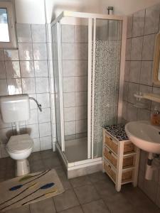 a bathroom with a shower and a toilet and a sink at L&L in Pakoštane +21 photos