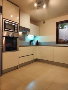 a kitchen with stainless steel appliances and a window at Golf & Spa resort with new big luxery appartement in Lorca