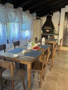 a dining room with a large wooden table and chairs at VILA MILICA & SPA ALEKSANDRA in Dimitrovgrad