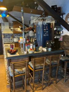 a kitchen with a counter with chairs at a bar at VILA MILICA & SPA ALEKSANDRA in Dimitrovgrad