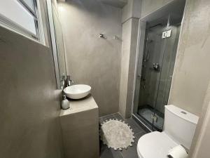 a bathroom with a sink and a toilet and a shower at Le Magne Apartments Kardamili in Kardamili