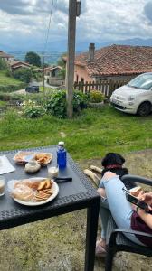 una persona sentada en una mesa con un plato de comida en Casa Tenada, en Robledo