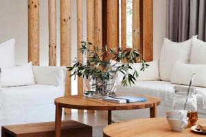 a living room with a couch and a table with a plant at Coco-Mat Hotel Nafsika in Athens