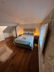 a bedroom with a bed and a dresser at A Portuguesa Guest House in Porto