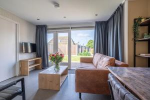 a living room with a couch and a table at Zeester in Serooskerke