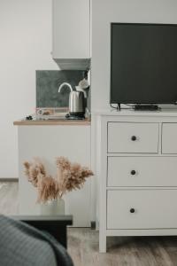 a white dresser with a television on top of it at Gallery Apartment 1 in Martin