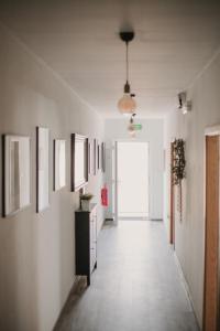 a hallway with paintings on the walls of a room at Gallery Apartment 1 in Martin