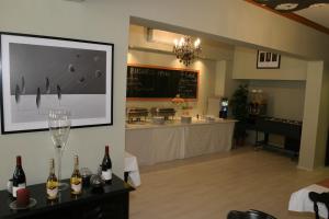 a room with a bar with bottles of wine and a counter at Hotel Gloria Budapest City Center in Budapest
