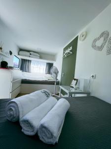 a bedroom with three towels on a bed at Glamping Langus in Topolšica