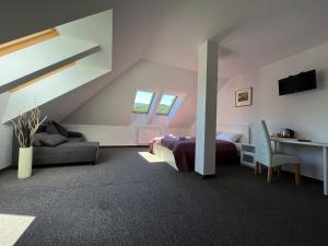 a attic bedroom with a bed and a desk at Gospoda Magurska in Sękowa